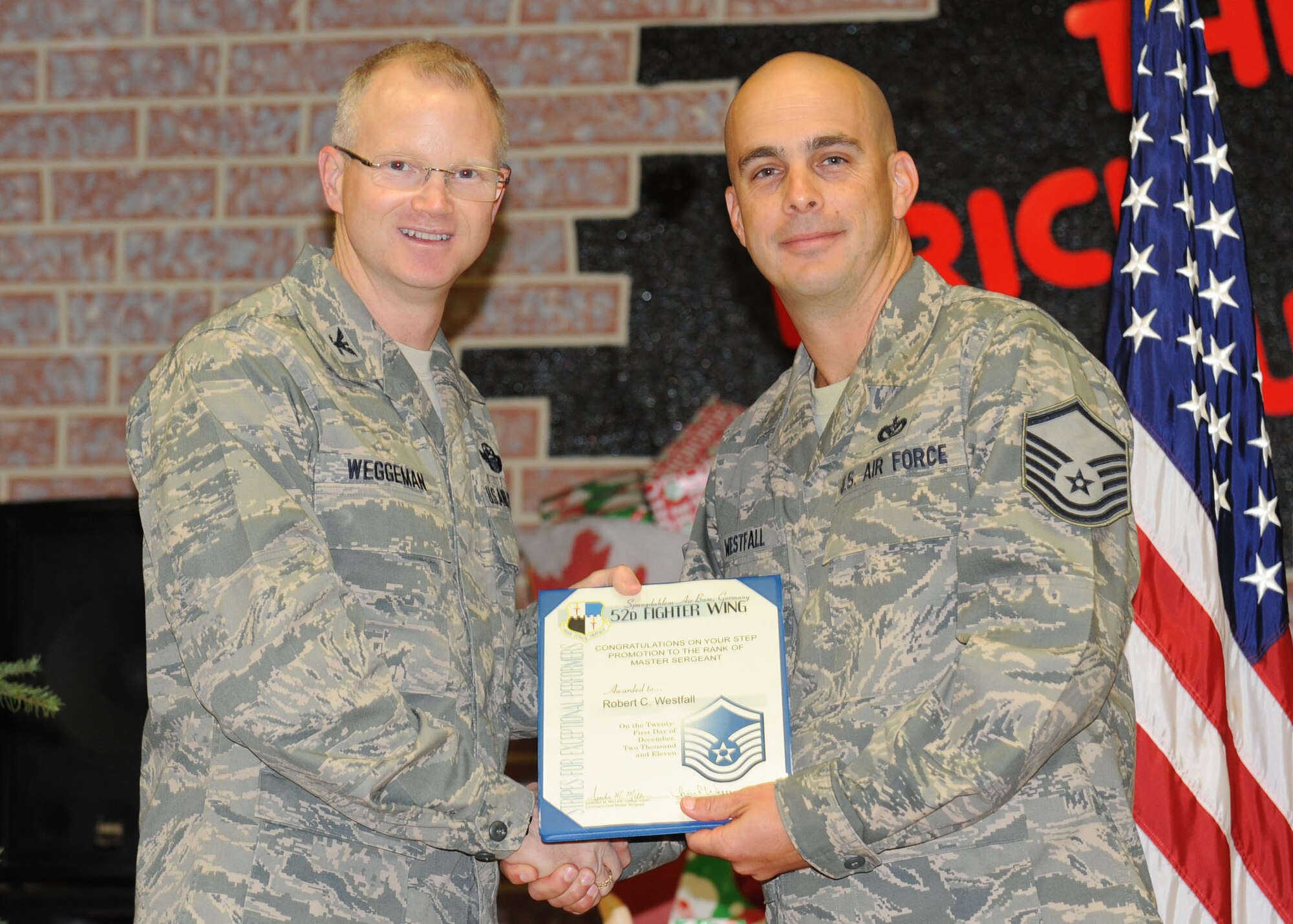 SPANGDAHLEM AIR BASE, Germany – Tech. Sgt. Robert Westfall, 52nd Civil Engineer Squadron NCO in charge of water and fuel systems maintenance, is promoted to the rank of master sergeant by Col. Chris Weggeman, 52nd Fighter Wing commander, under the Stripes for Exceptional Performers program here Dec. 21, 2011. Each year, a limited number of Airmen receive a STEP promotion for their continued outstanding work. (U.S. Air Force photo/Senior Airman Christopher Toon)