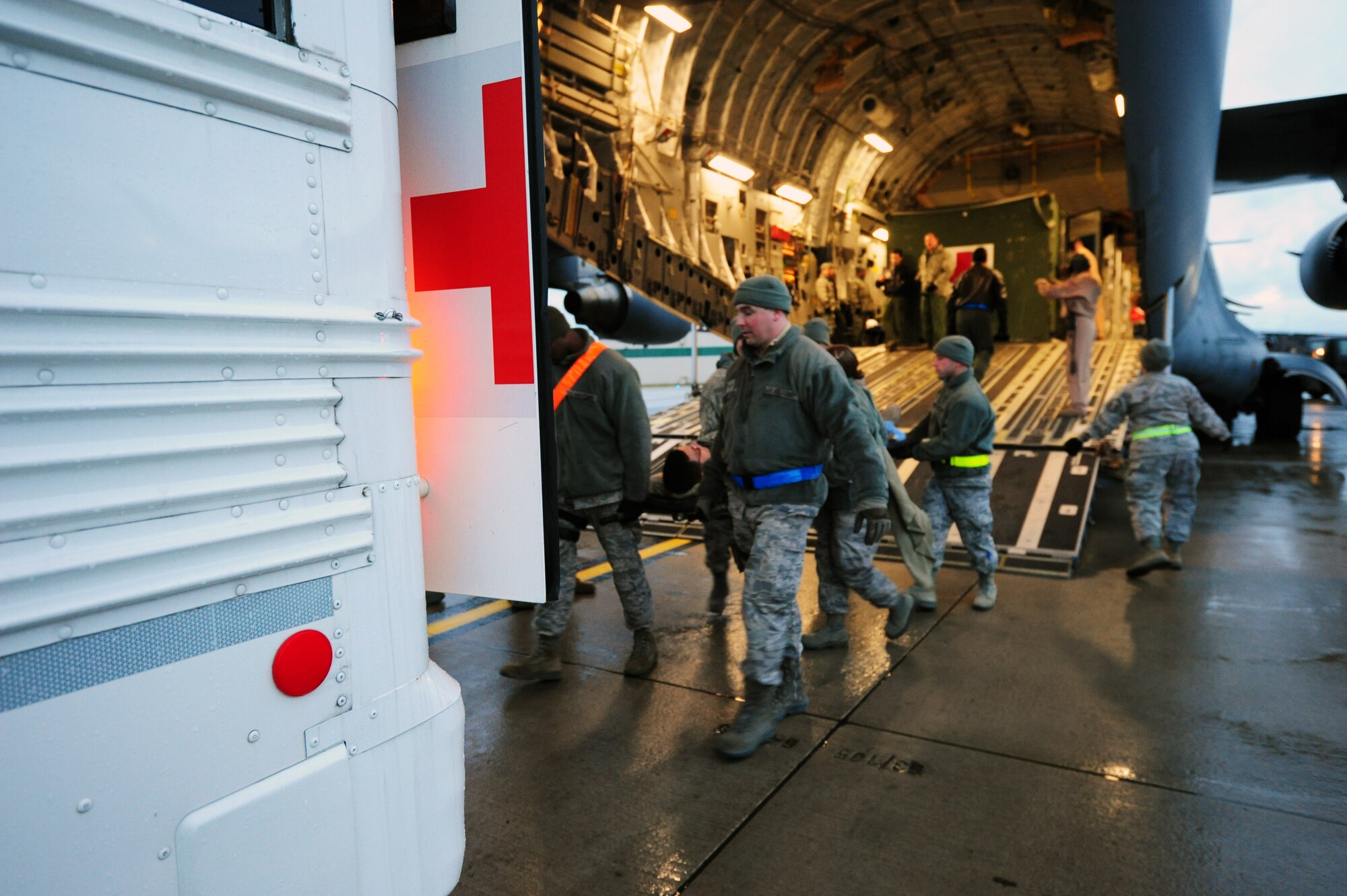 Flight medics move wounded warriors off of a C-17 Globemaster III, at Ramstein Air Base, Dec. 14, 2011. Bulgarian Military Medical members came to Ramstein to learn how the Contingency Aeromedical Staging Facility personnel move wounded warriors out of the battlefield. (U.S. Air Force photo/Senior Airman Aaron-Forrest Wainwright) 