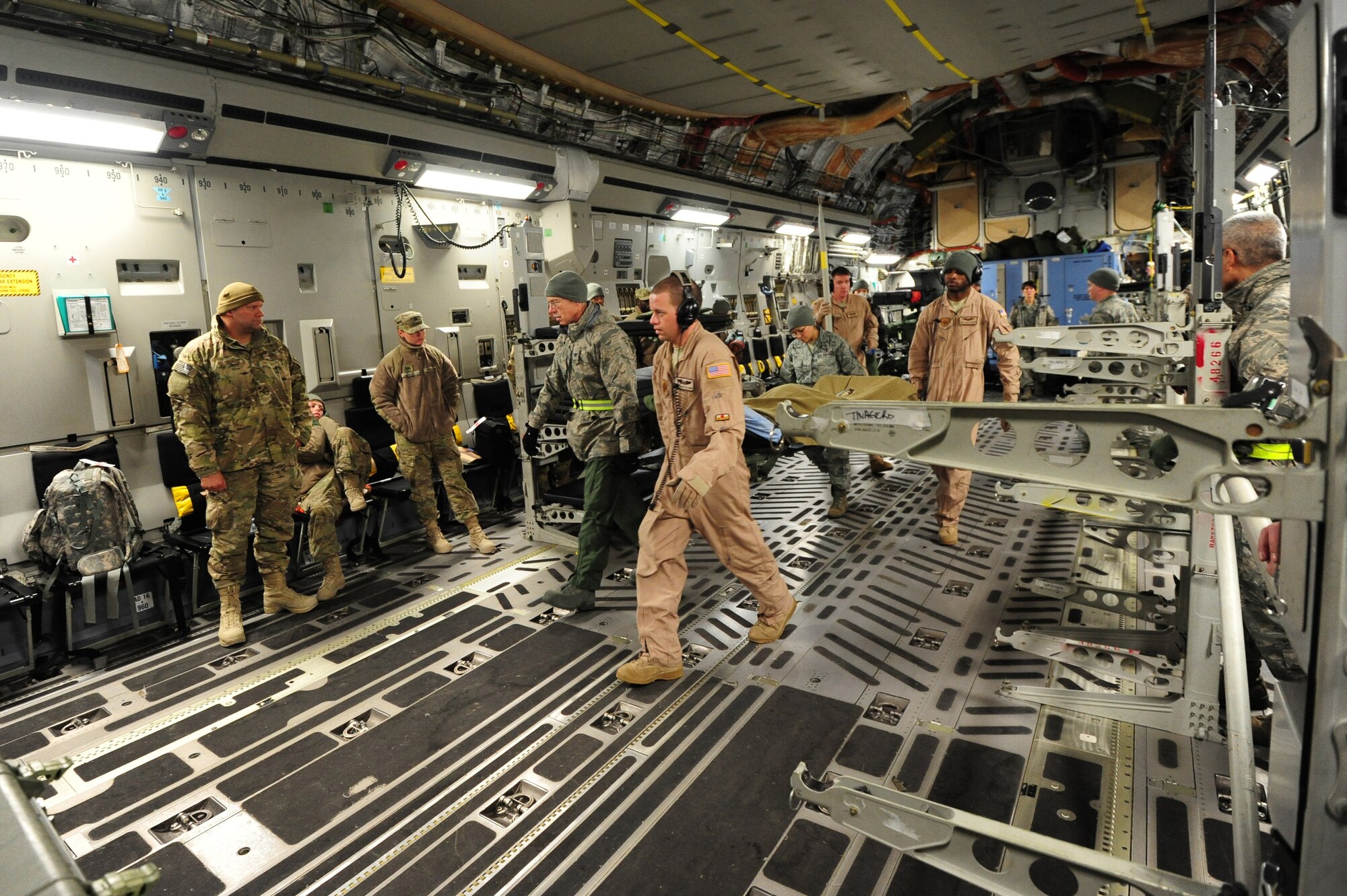 Flight medics move wounded warriors off of a C-17 Globemaster III, Ramstein Air Base, Dec. 14, 2011. Bulgarian military medical members came to Ramstein to learn how the Contingency Aeromedical Staging Facility personnel move wounded warriors out of the battlefield. (U.S. Air Force photo/Senior Airman Aaron-Forrest Wainwright) 