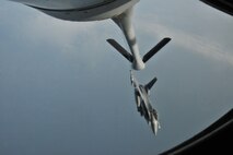 A KC-135 Stratotanker of the 909th Air Refueling Squadron from Kadena Air Base, Japan, refuels an F-16 Fighting Falcon during a training mission off the coast of the Republic of Korea, Dec. 28, 2011. As part of a joint effort between the 80th Fighter Squadron and the 909th ARS, military spouses visiting the area were given the opportunity to fly on the KC-135 during the aerial refueling. (U.S. Air Force photo by Senior Airman Brittany Y. Auld/Released)