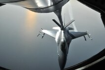 A KC-135 Stratotanker of the 909th Air Refueling Squadron from Kadena Air Base, Japan, refuels an F-16 Fighting Falcon during a training mission off the coast of the Republic of Korea, Dec. 28, 2011. As part of a joint effort between the 80th Fighter Squadron and the 909th ARS, military spouses visiting the area were given the opportunity to fly on the KC-135 during the aerial refueling. (U.S. Air Force photo by Senior Airman Brittany Y. Auld/Released)