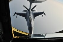 A KC-135 Stratotanker of the 909th Air Refueling Squadron from Kadena Air Base, Japan, refuels an F-16 Fighting Falcon during a training mission off the coast of the Republic of Korea, Dec. 28, 2011. As part of a joint effort between the 80th Fighter Squadron and the 909th ARS, military spouses visiting the area were given the opportunity to fly on the KC-135 during the aerial refueling. (U.S. Air Force photo by Senior Airman Brittany Y. Auld/Released)