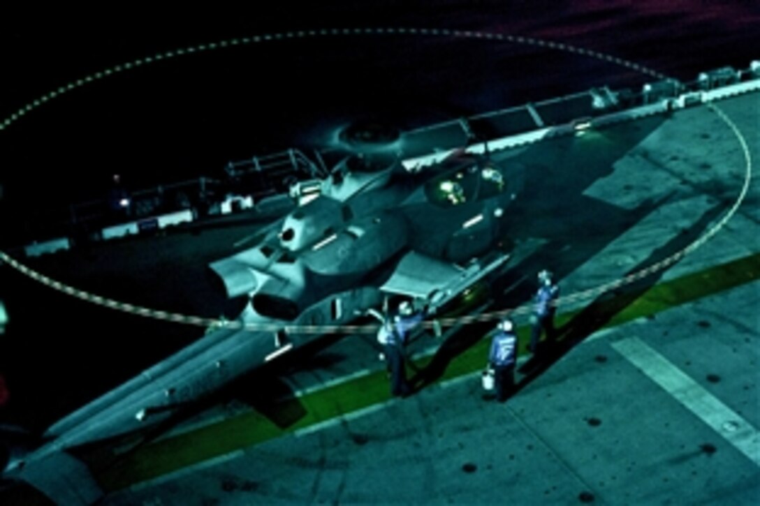 U.S. sailors conduct a hot refueling of a AH-1 Cobra attack helicopter during night flight operations aboard the USS Makin Island in the Indian Ocean, Dec. 30, 2011. The sailors are aviation boatswain’s mates, and the Cobra crew is assigned to the Red Dragons of Marine Medium Helicopter Squadron 268 Reinforced. Makin Island is on its maiden deployment and conducting operations in the U.S. 7th Fleet area of responsibility.