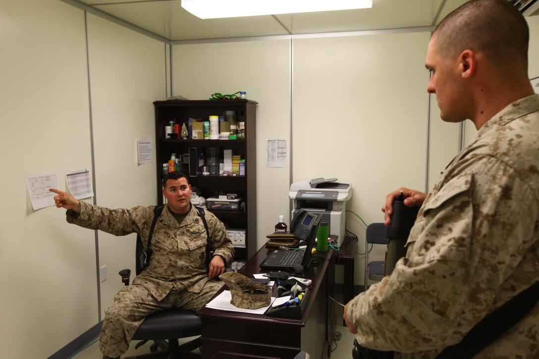 Petty Officer 2nd Class James Vanzella, the religious program specialist for Regimental Combat Team 6, talks to a Marine with RCT-6 about receiving care packages. An RP’s duties can consist of protecting chaplains, helping chaplains coordinate religious services and handling administrative issues with running a chapel.