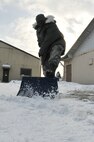 Staff Sgt. Rasheen Douglas, 8th Fighter Wing public affairs photography NCO in charge, shovels snow at Kunsan Air Base, Republic of Korea, Jan. 4, 2012. The Wolf Pack enjoyed their first snow day of the year. (U.S. Air Force photo by Senior Airman Brittany Y. Auld/Released)