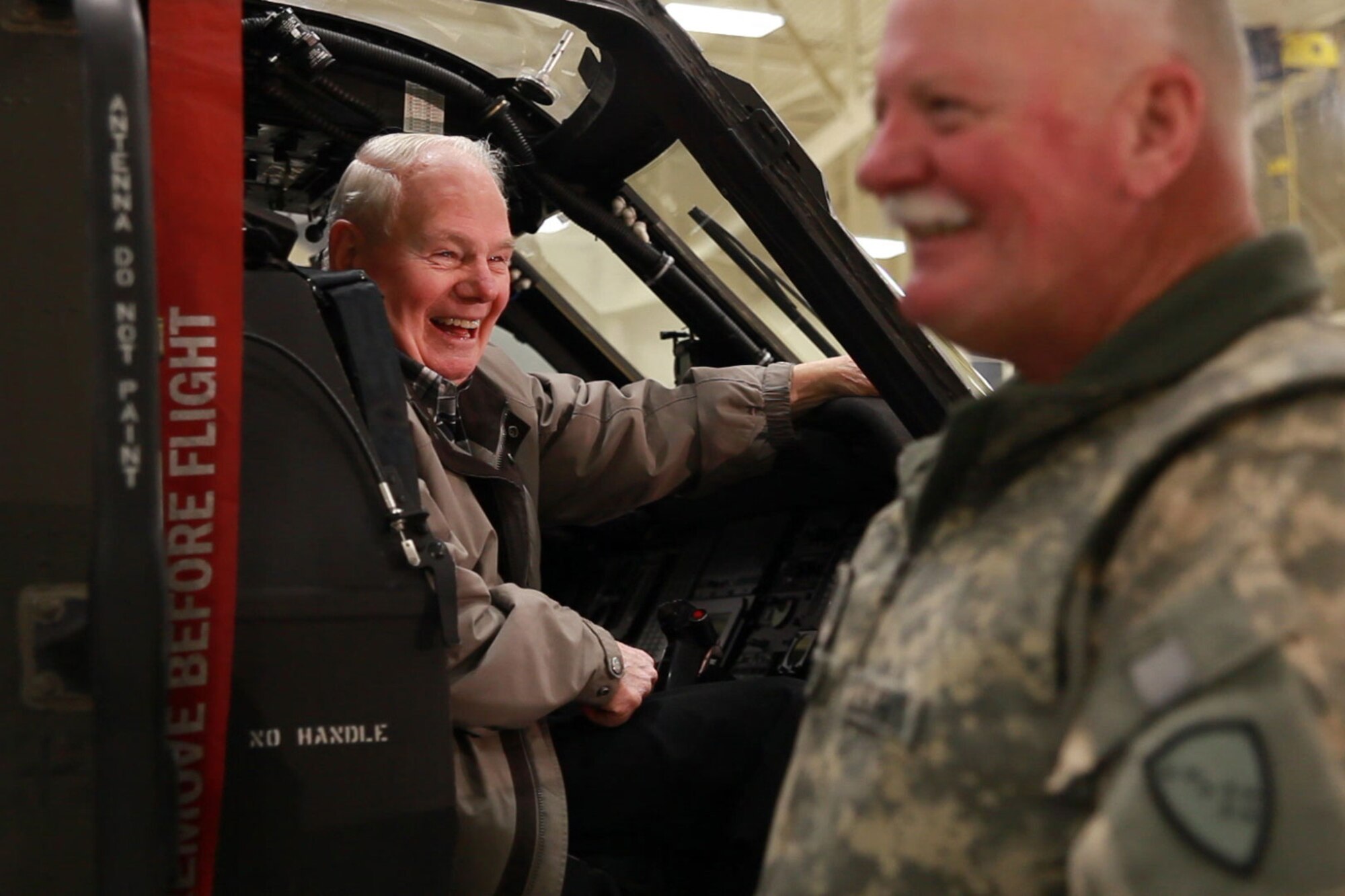 Col. (ret) John Spalding, left, and Chief Warrant Officer Dave Benesch, Alaska Army National Guard, share a laugh while Spalding sits in an Alaska Army National Guard UH-60 Black Hawk helicopter at Bryant Army Airfield in December 2011. Photo: 2nd Lt Bernie Kale, DMVA Public Affairs