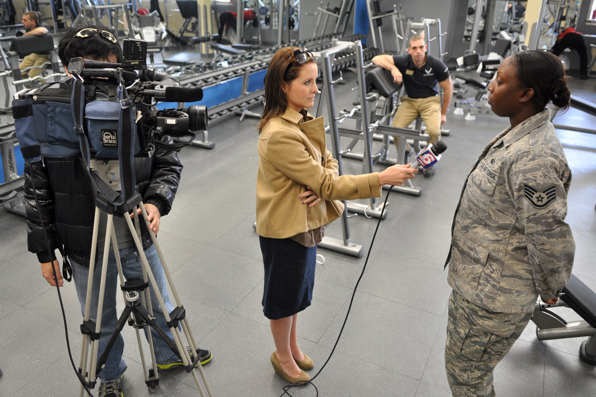 Staff Sgt. Tinisha Lawson, a fitness specialist assigned to the 2nd Force Support Squadron, explains the benefits of a good physical fitness plan to Leslie Draffin, who is a reporter for KTAL Channel 6 in Shreveport, La., at the Fitness Center on Barksdale Air Force Base, La., Jan. 4, 2012. Draffin was at Barksdale with her cameraman Chang Howang to report on people’s New Year’s Resolutions to become more fit during 2012, as well as the remodeling progress of the Fitness Center. A Re-Grand opening is scheduled for Jan. 9, 2012. (U.S. Air Force photo by Master Sgt. Jeff Walston/Released) 
