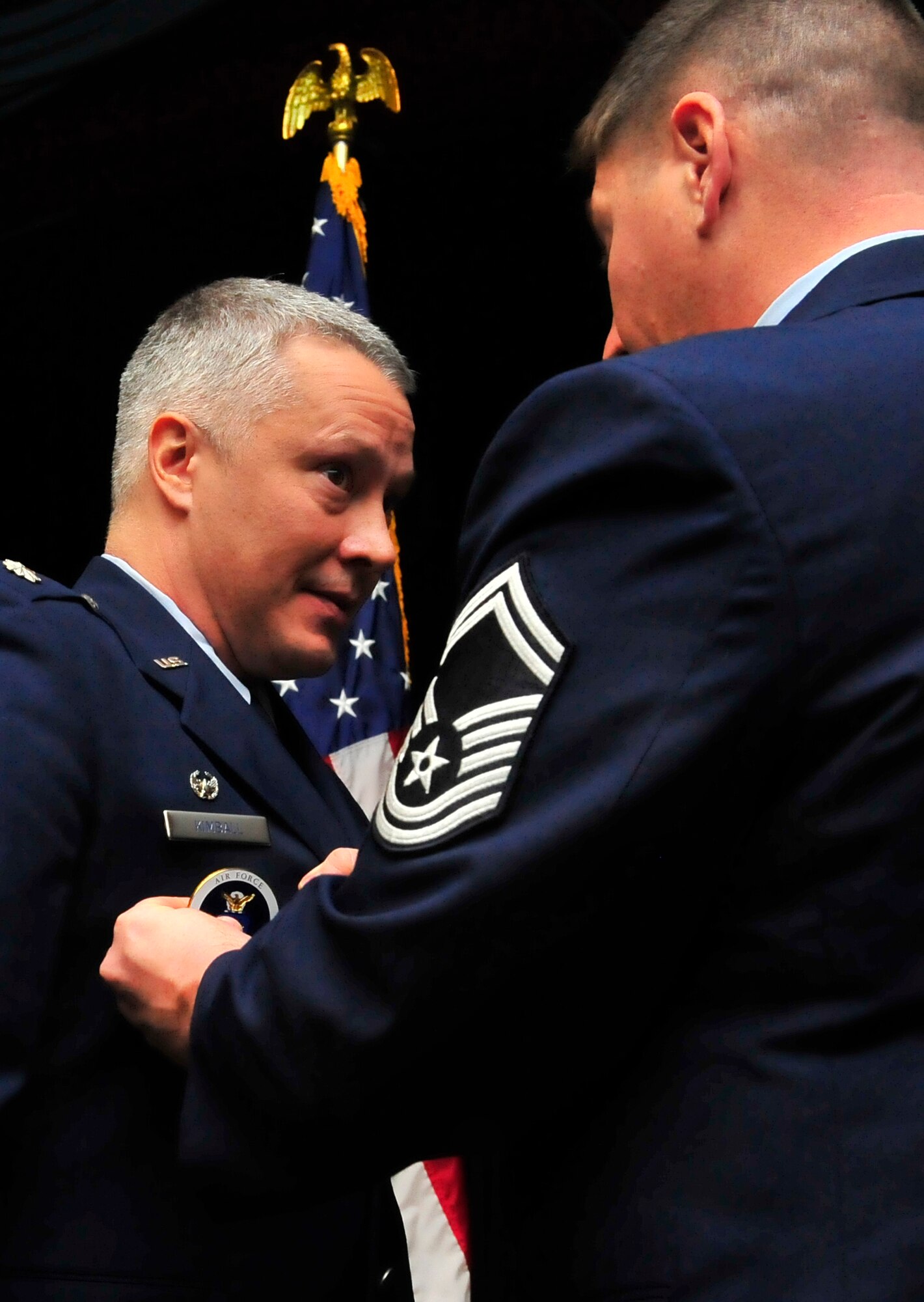 U.S. Air Force Lt. Col. Troy Kimball, 337th Recruiting Squadron commander, receives the recruiting badge from Senior Master Sgt. Kenneth Adamczyk, 337th RCS production superintendent, during the 337th RCS change of command ceremony at the Community Activity Center Jan. 4, 2012, Shaw Air Force Base, S.C. Kimball assumed command of the 337th RCS from Lt. Col. Mathew Hughbanks at the ceremony. (U.S. Air Force photo by Senior Airman Amber E. N. Jacobs/Released) 