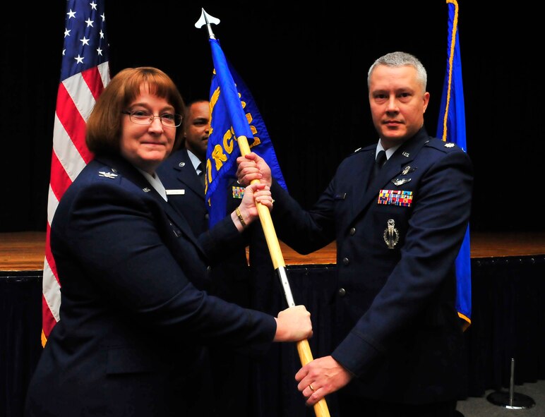 U.S. Air Force Lt. Col. Troy Kimball, 337th Recruiting Squadron commander, receives the 337th RCS flag from Col. Cynthia Brown, 360th Recruiting Group commander, while taking command during the 337th RCS change of command ceremony on Jan. 4, 2012, Shaw Air Force Base, S.C. Airmen from the 337th RCS came together at the Community Activity Center to welcome their new commander. Kimball assumed command of the 337th RCS from Lt. Col. Mathew Hughbanks at the ceremony. (U.S. Air Force photo by Senior Airman Amber E. N. Jacobs/Released) 