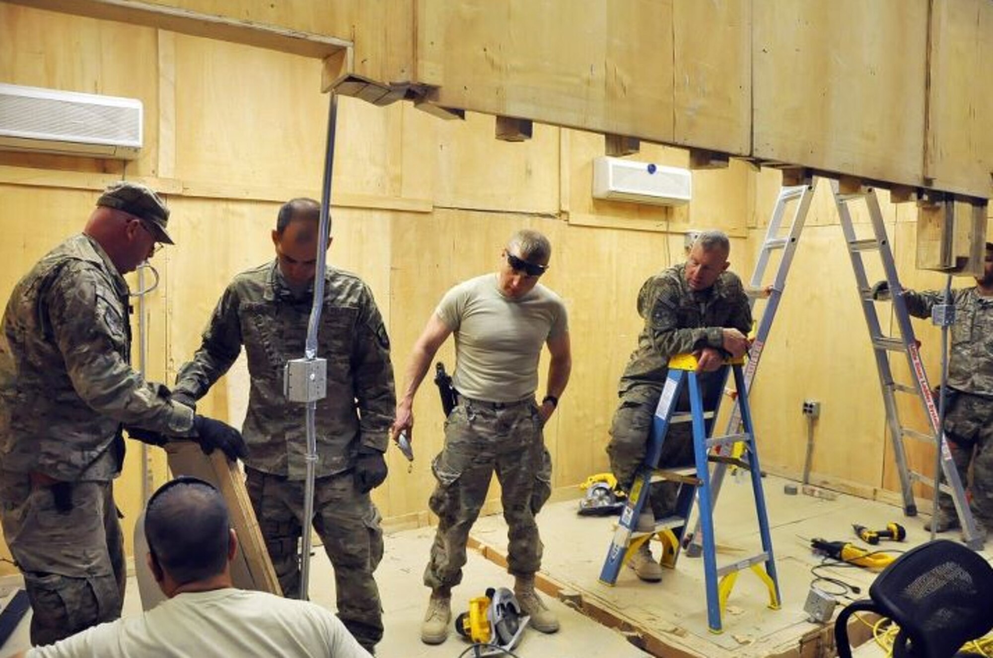 Air Force Civil Engineers assigned to the 577th Expeditionary Prime Beef Squadron rest after a partial demolition the back portion of the 3rd Brigade Combat Team, 1st Armored Division Joint Operations Center located on Forward Operating Base Shank. The Air Force Civil Engineers consist of structural, electrical, and plumbing specialists who often have worked in the construction industry for more than 10 years; often times has a two or more construction degrees, and is self-employed; either owning or working in a family – run construction business. (U.S. Army photo/Sgt. John D. Ortiz)