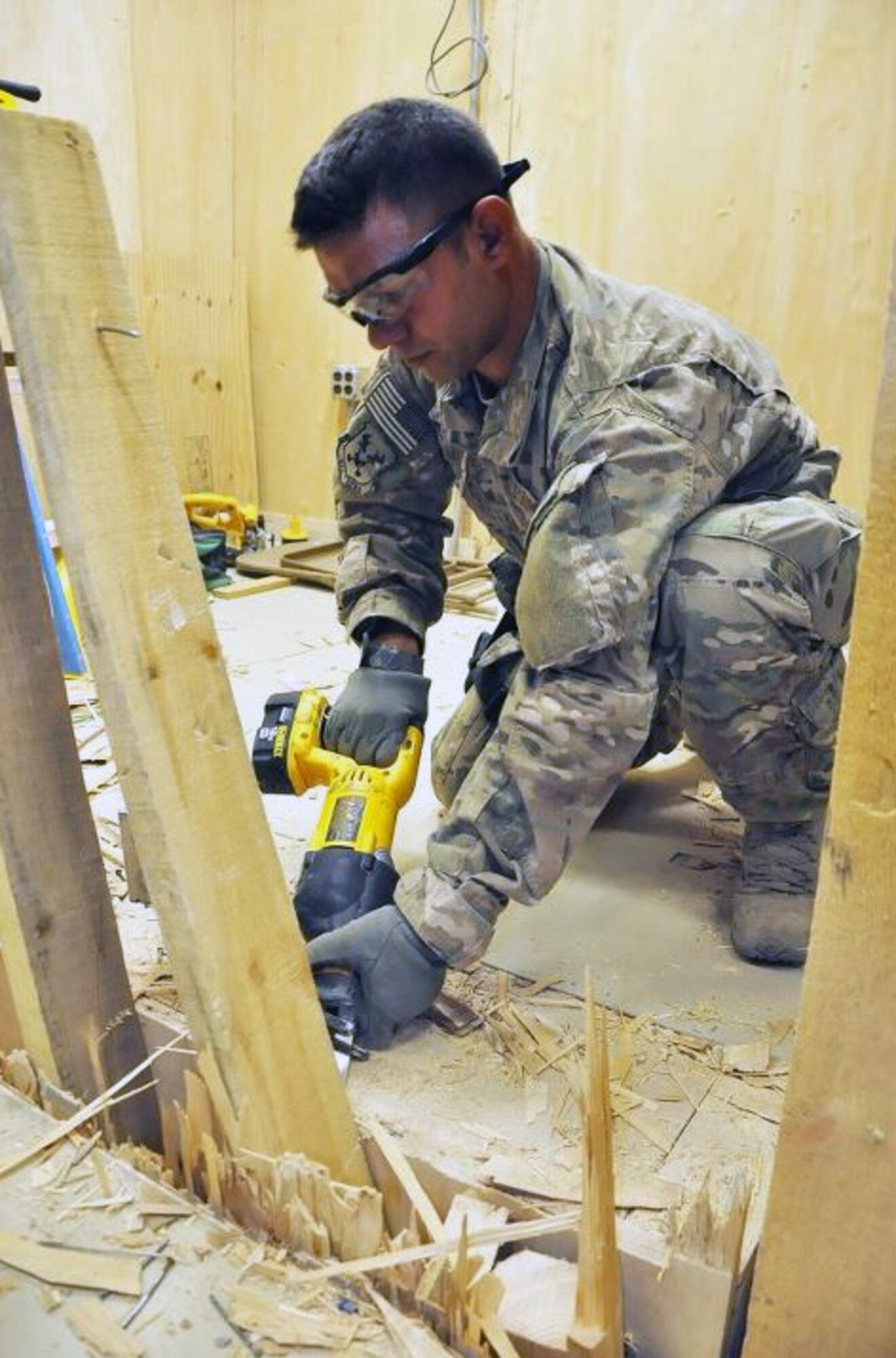 Air Force Tech. Sgt. said Tech. Sgt. Daniel Romine, a Farmington, Mo., native uses a reciprocating saw to cut wooden supports while demolishing part of the 3rd Brigade Combat Team, 1st Armored Division Joint Operations Center for an idea to expand the back portion to improve communication in the JOC. Romine is a member 442 Fighter Wing at Whiteman Air Force Base, Mo., when he is not deployed. (U.S. Army photo/Sgt. John D. Ortiz)