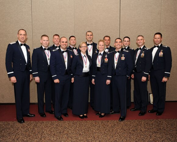 Members and guests of the U.S. Air Force Advanced Maintenance and Munitions Officer School Combat Support Course, Class 11B pose for a picture Dec. 16, 2011, during a graduation ceremony at Nellis Air Force Base, Nev.  The graduates will return to their home units and will produce, instruct and advise others in all aspects of effects-based logistics using their newly-gained knowledge from the AMMOS course.  Front row, from left: Maj. Gen. John Cooper, Capt. Brian Sinkule, Capt. Candido Mendes Jr., Capt. Kathryn Mobley, Capt. Amanda McFeeters and Capt. Wesley Wade. Back row, from left: Capt. Jason Purcell, Capt. Jason Moehle, Capt. Warren Smith, Capt. Steven Melton, Capt. James Gutierrez, Capt. Robert Dossman and Lt. Col. William Maxwell.  (U.S. Air Force photo by Staff Sgt. Taylor Worley/Released)