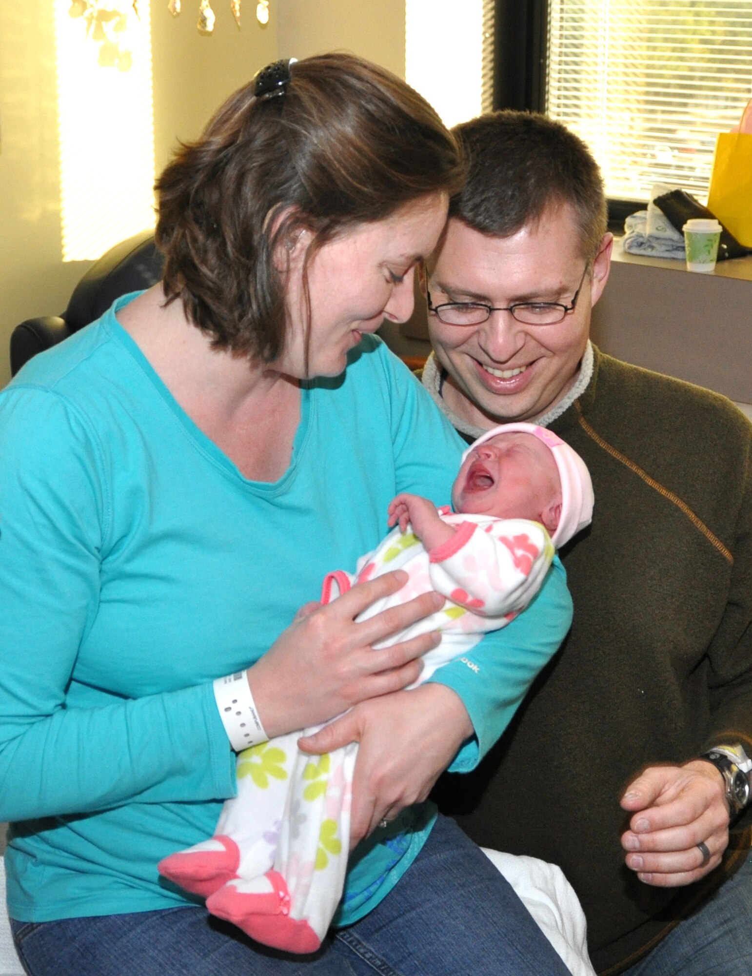 Capt. (Dr.) Timothy and Sandra Davis hold their new daughter Elizabeth in the Keesler Hospital Family Birthing Center Jan. 3.  Elizabeth was born 8:37 a.m. Jan. 2, making her Keesler Air Force Base’s first 2012 baby.  She “weighed in” at 8 pounds, 4 ounces and measured 21-1/4-inches “tall.”  She will join brothers Grant, almost 6, and William, 28 months in their Ocean Springs home.  Dr. Davis is a second-year internal medicine resident assigned to the 81st Medical Operations Squadron.  (U.S. Air Force photo by Steve Pivnick)