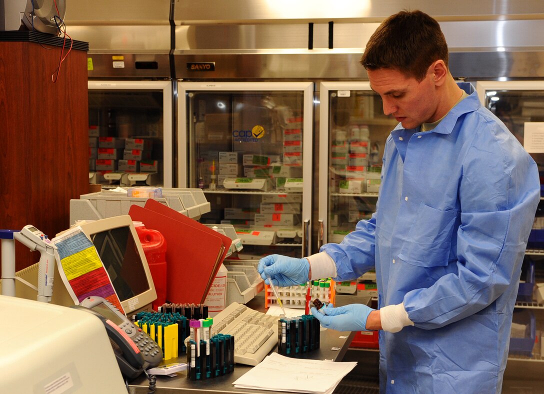 Airman 1st Class Lance Gillenwater, 28th Medical Support Squadron medical laboratory technician, conducts tests on blood samples on Ellsworth Air Force Base, S.D., Dec. 27, 2011. Gillenwater verifies the results of the tests after the samples have been ran through a chemistry analyzer. (U.S. Air Force photo by Airman 1st Class Zachary Hada/Released)
