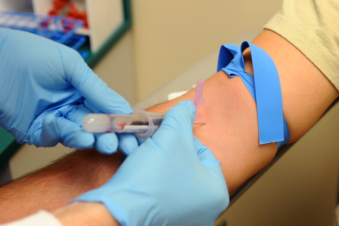 Airman 1st Class Joseph Deboes, 28th Medical Support Squadron medical laboratory technician, extracts blood from Staff Sgt. Carter Norrie, 28th Aircraft Maintenance Squadron weapon loads team chief during a health examination on Ellsworth Air Force Base, S.D., Dec. 27, 2011. Airmen are required to have annual check-ups to keep themselves fit to fight. (U.S. Air Force photo by Airman 1st Class Zachary Hada/Released)