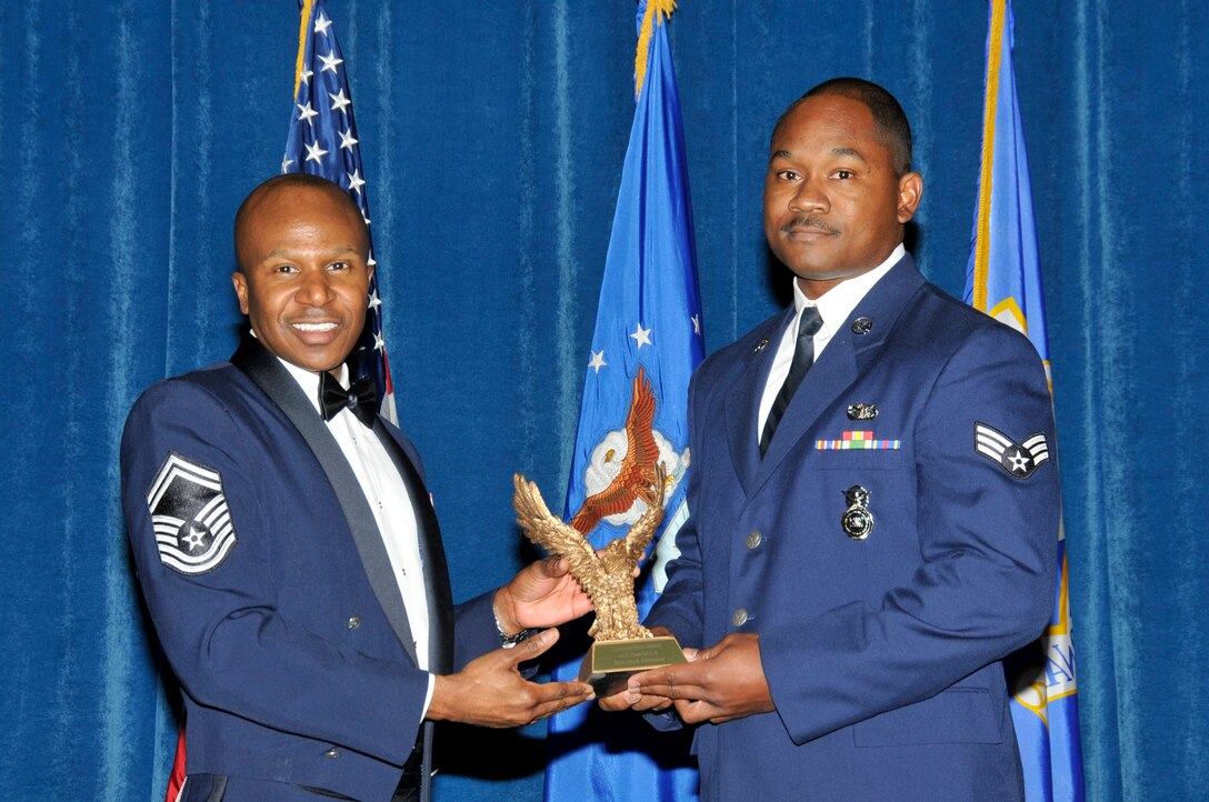 McGHEE TYSON AIR NATIONAL GUARD BASE, Tenn. -- Senior Airman Jerod Simmons, right, receives the Paul H. Lankford leadership award for Airman Leadership School Class 11-8 at The I.G. Brown Air National Guard Training and Education Center from Senior Master Sgt. Tyrone F. Bingham, EPME Director of Education, Oct. 28, 2011.  The leadership award is presented to the student who made the most significant contribution to the overall success of the class by demonstrating superior leadership abilities and excellent skills as a team member.  It is named in honor of CMSgt Paul H. Lankford, a Bataan Death March survivor and the first commandant of the Air National Guard Enlisted Professional Military Education Center.  (U.S. Air Force photo by Master Sgt. Kurt Skoglund/Released)