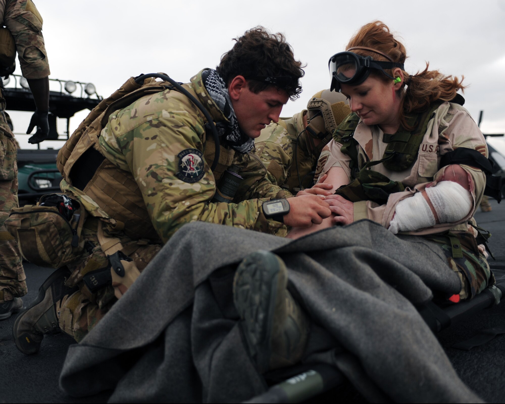 U.S. Air Force Senior Airman Jason Sweet, 306th Rescue Squadron pararescueman, removes a needle from a moulaged augmentee’s arm during the Operation Shocker exercise held at Gila Bend Auxiliary Field, Ariz., Dec. 14, 2011. The exercise tested the 943rd Rescue Group’s ability to respond to a variety of combat search and rescue scenarios prior to an upcoming deployment. (U.S. Air Force photo by Airman 1st Class Christine Griffiths/Released)
