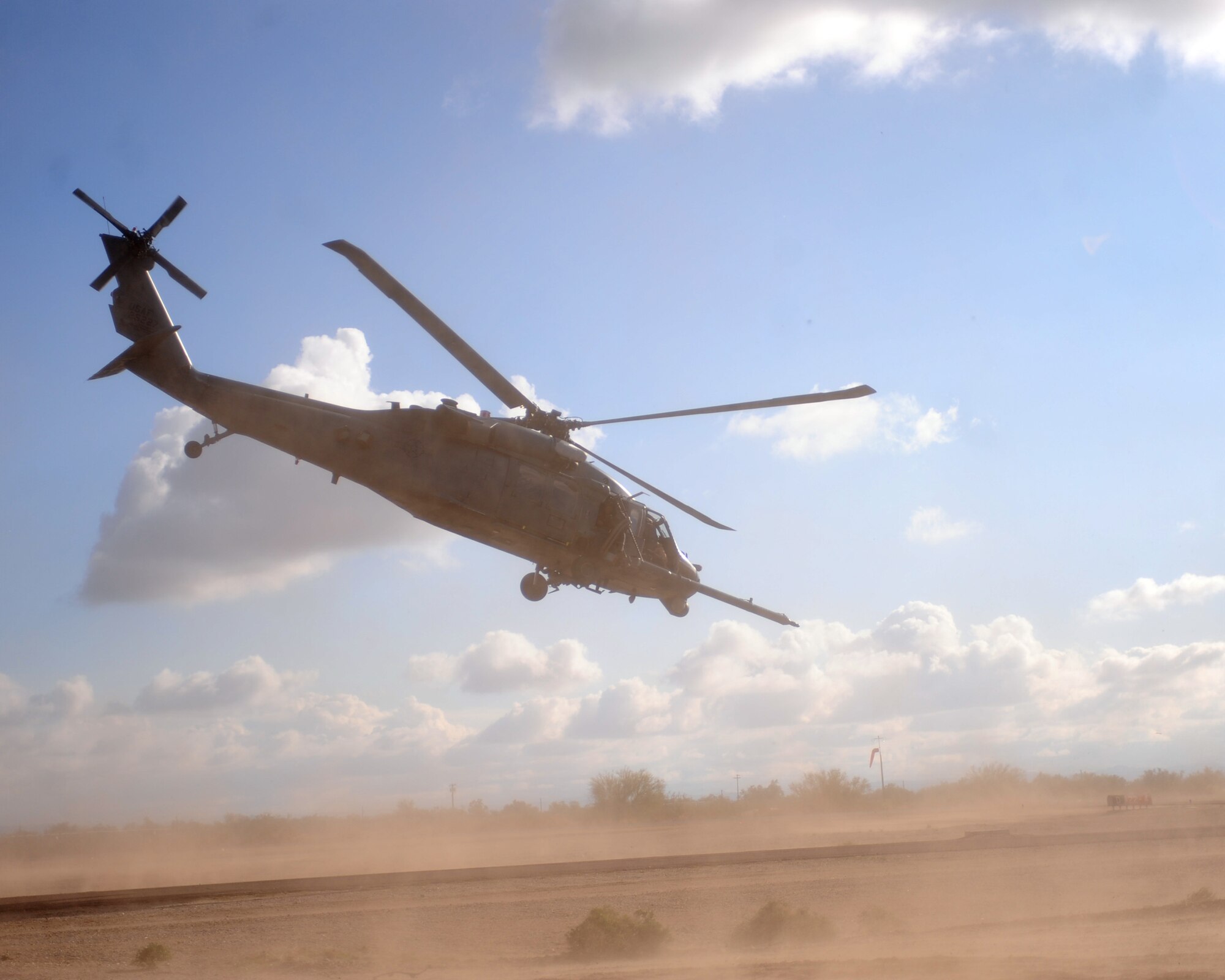 An HH-60G Pave Hawk takes off with the moulaged augmentees onboard during the Operation Shockers exercise at Gila Bend Auxiliary Field, Ariz., Dec. 14, 2011. (U.S. Air Force photo by Airman 1st Class Christine Griffiths/Released)