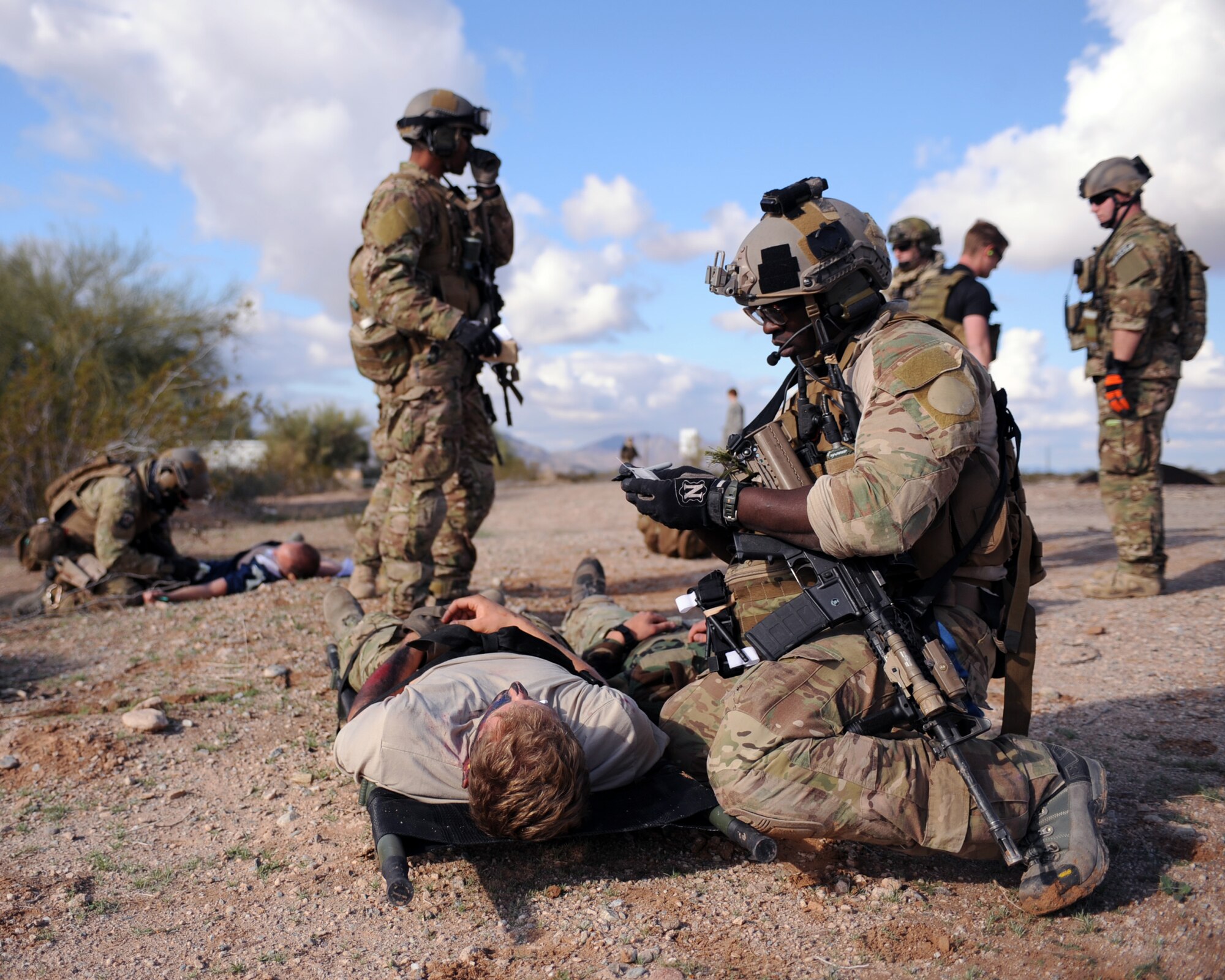 U.S. Air Force Staff Sgt. David Adams, 306th Rescue Squadron pararescueman, makes note of injuries on a moulaged augmentee during the Operation Shocker exercise at Gila Bend Air Force Auxiliary Field, Ariz., Dec. 14, 2011. The exercise tested the 943 Rescue Group’s ability to respond to a variety of combat search and rescue scenarios prior to an upcoming deployment. (U.S. Air Force photo by Airman 1st Class Christine Griffiths/Released)