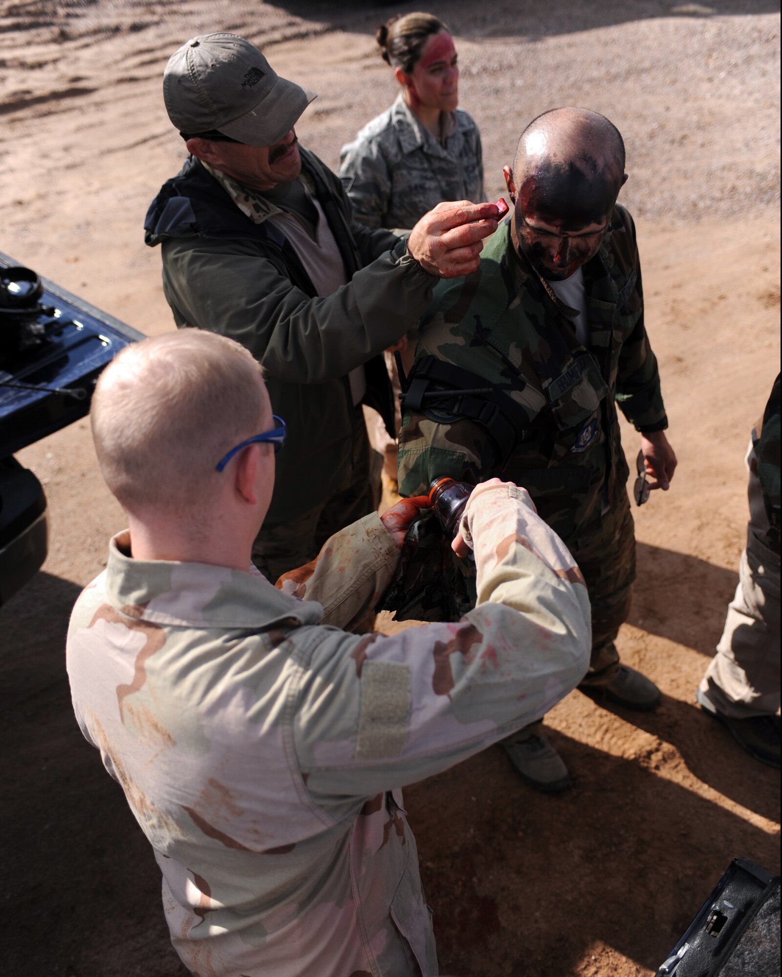 An augmentee gets moulaged during the Operation Shocker exercise at Gila Bend Air Force Auxiliary Field, Ariz., Dec. 14, 2011. (U.S. Air Force photo by Airman 1st Class Christine Griffiths/Released)