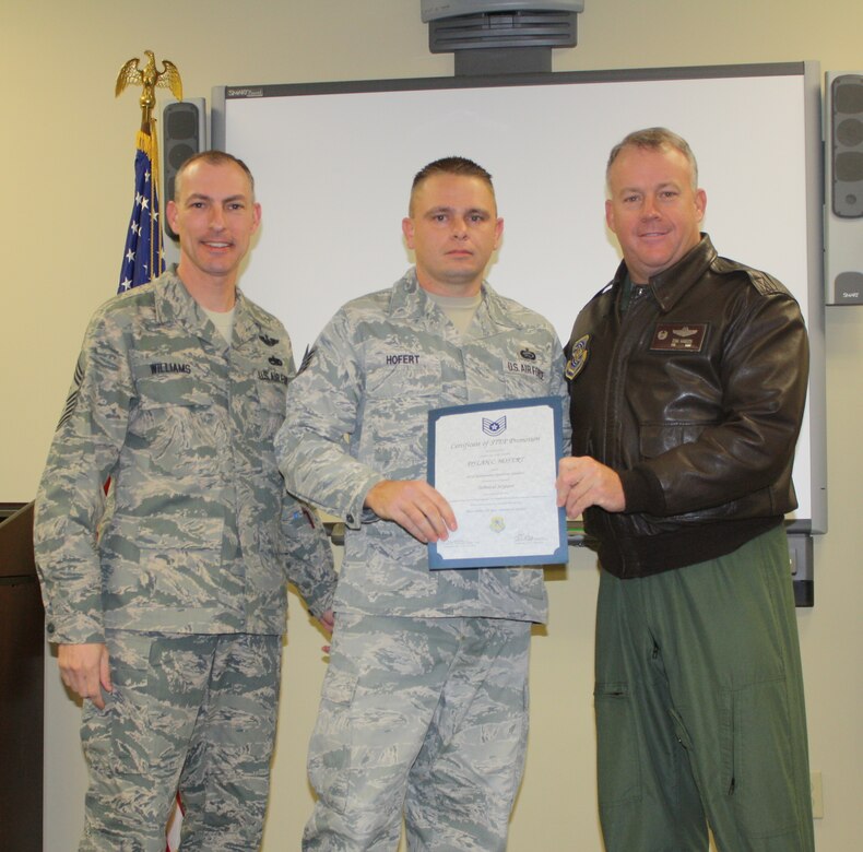 Colonel Erik Hansen and Chief Master Sgt. Larry Williams congratulate Tech. Sgt. Dylan Hofert after his promotion via the Stripes for Exceptional Performers promotion Jan. 3 at Joint Base Charleston – Air Base. Hofert is the 437th Maintenance Operations Squadron Unit Training manager, Hansen is the 437th Airlift Wing commander and Williams is the 437 AW command chief. (U.S. Air Force photo/Jessica Lovette)