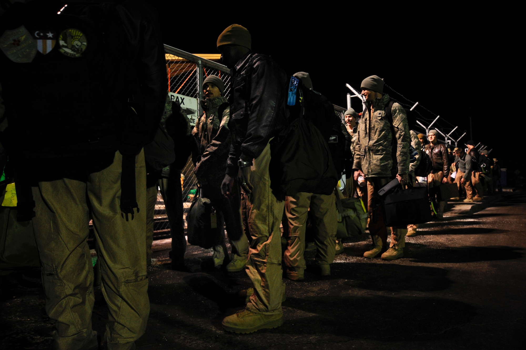 Airmen wait patiently in a line outside of the passenger terminal Jan. 3, 2012 at the Transit Center at Manas, Kyrgyzstan. The Passenger terminal processes approximately 800 passengers a day and is responsible for all inbound and outbound passengers of International efforts in Afghanistan. (U.S. Air Force Photo/Staff Sgt. Angela Ruiz)