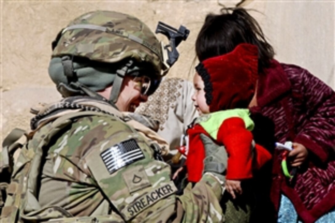 U.S. Army Pfc. Sierra Streacker interacts with Afghan children in Afghanistan's Ghazni province, Dec. 31, 2011. Streacker is assigned to the 25th Infantry Division's Company F, 2nd Battalion, 5th Infantry Regiment.