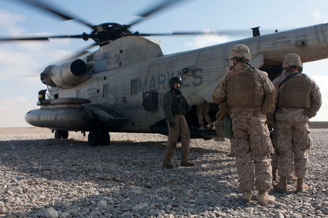 U.S. Marines of 1st Radio Battalion, 2D Marine Expeditionary Force (Forward), load onto a CH-53D Sea Stallion helicopter of Marine Heavy Helicopter Squadron 363 (HMH-363) during a routine flight operation, Forward Operating Base Edinburgh, Helmand Province, Afghanistan, Jan. 5, 2012. HMH-363 conducted flight operations in support of troops throughout the Helmand Province. (U.S. Marine Corps photo by Lance Cpl. Robert R. Carrasco/Released).