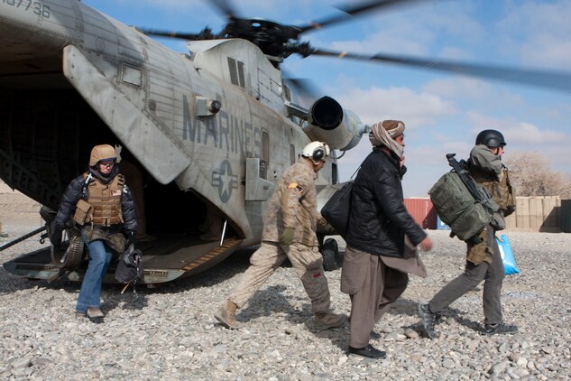 Personnel disembark a U.S. Marine Corps CH-53D Sea Stallion helicopter of Marine Heavy Helicopter Squadron 363 (HMH-363), Forward Operating Base Musa Qal'eh, Helmand Province, Afghanistan, Jan. 5, 2012. HMH-363 conducted flight operations in support of troops throughout the Helmand Province. (U.S. Marine Corps photo by Lance Cpl. Robert R. Carrasco/Released).