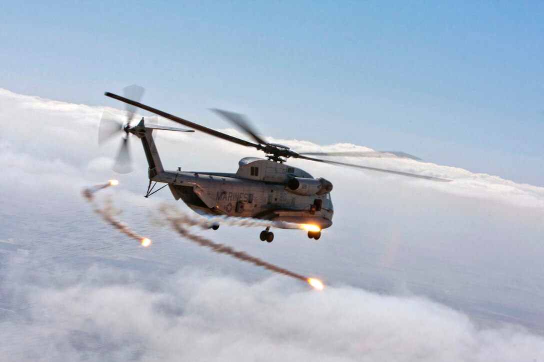 Flares are discharged from a U.S. Marine Corps CH-53D Sea Stallion helicopter of Marine Heavy Helicopter Squadron 363 (HMH-363) during a routine flight operation, Helmand River Valley, Helmand Province, Afghanistan, Jan. 5, 2012. Marine pilots of HMH-363 utilize flares ensuring the safety of the crew onboard and safe guarding the aircraft while in flight during poor visibility weather. (U.S. Marine Corps photo by Lance Cpl. Robert R. Carrasco/Released).