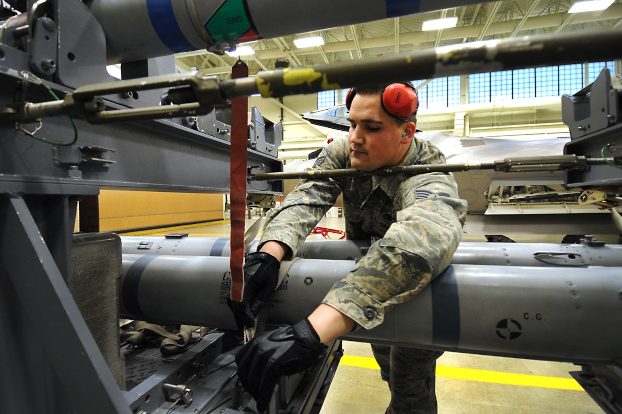 JOINT BASE ELMENDORF-RICHARDSON, Alaska --Senior Airman Caleb Hill preps an air intercept missile 9 for load during the weapons load crew of the year competition Dec. 14. Three teams competed for the annual award after winning a quarterly competition. Hill is an aircraft armament systems specialist with the 90th Aircraft Maintenance Unit. (U.S. Air Force photo/Staff Sgt. Cynthia Spalding) 
