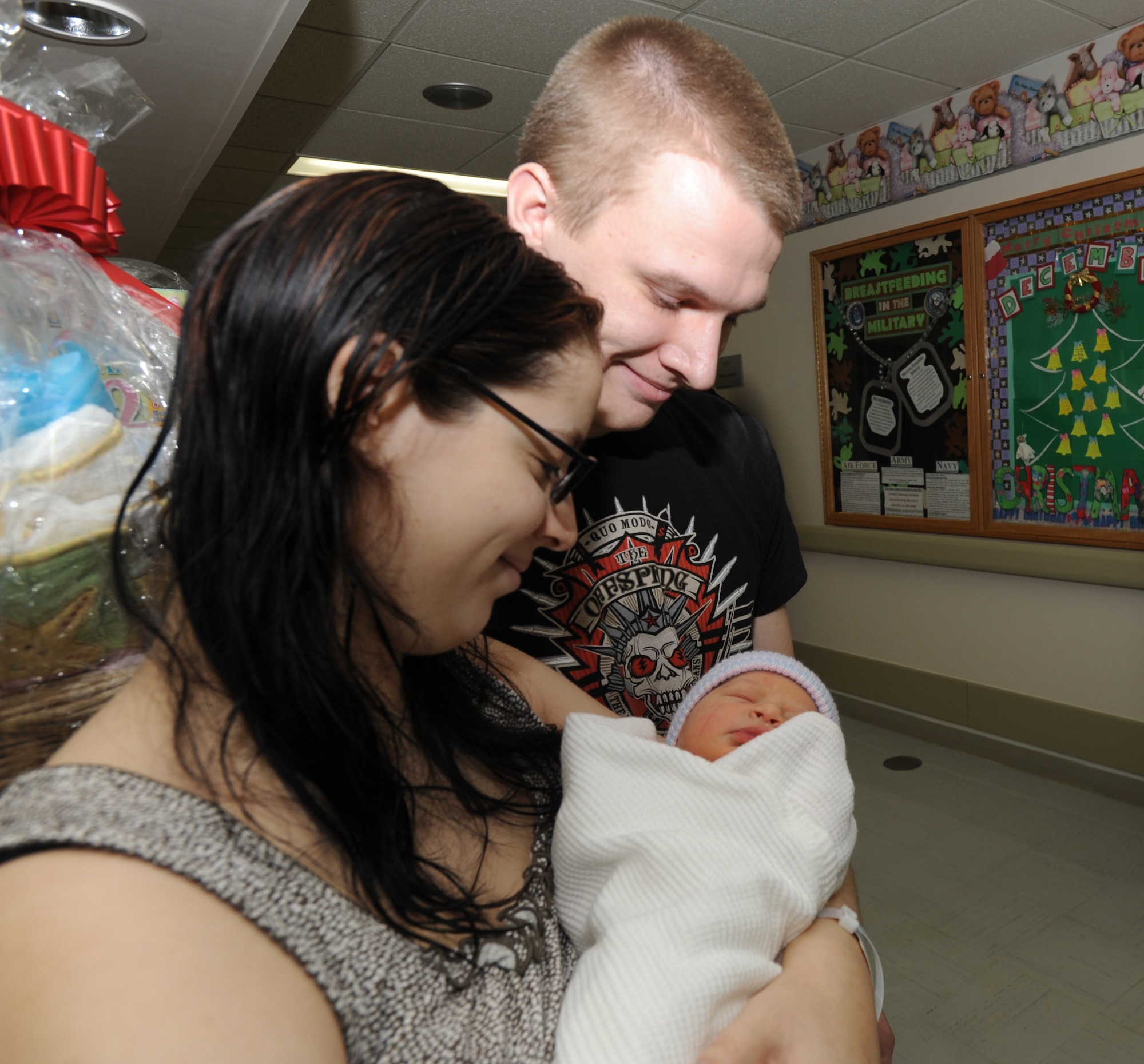 MISAWA AIR BASE, Japan – U.S. Air Force Airman 1st Class Kyle Hawkins, 35th Force Support Squadron, Falcon Feeder shift leader and his wife, Julianna Hawkins, fondly hold their infant son, Adam, at the base hospital, Jan. 3, 2012. The Hawkins’ first born was delivered at 10:31 p.m. New Years day. The family has prepared a room for Adam, which was decorated with an ocean theme. (U.S. Air Force photo/Airman Kenna Jackson)