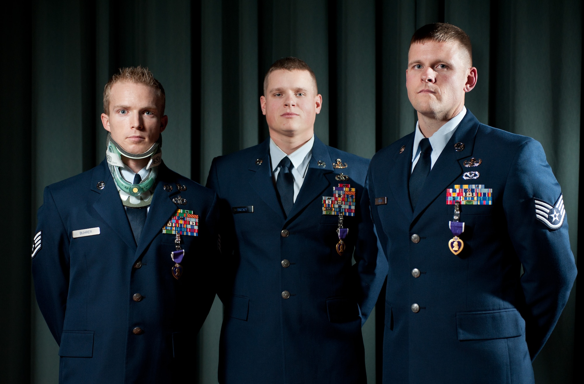 Left to right: Staff Sgt. Brian Buhrer, Tech. Sgt. Ronnie Brickey and Staff Sgt. David Adkins, all 60th Civil Engineer Squadron explosive ordnance disposal flight members, were injured during improvised explosive device attacks in combat missions while deployed to Afghanistan. They were awarded the Purple Heart Jan. 5 for injuries they sustained during their deployments in support of Operation Enduring Freedom. (U.S. Air Force photo/Ken Wright)  