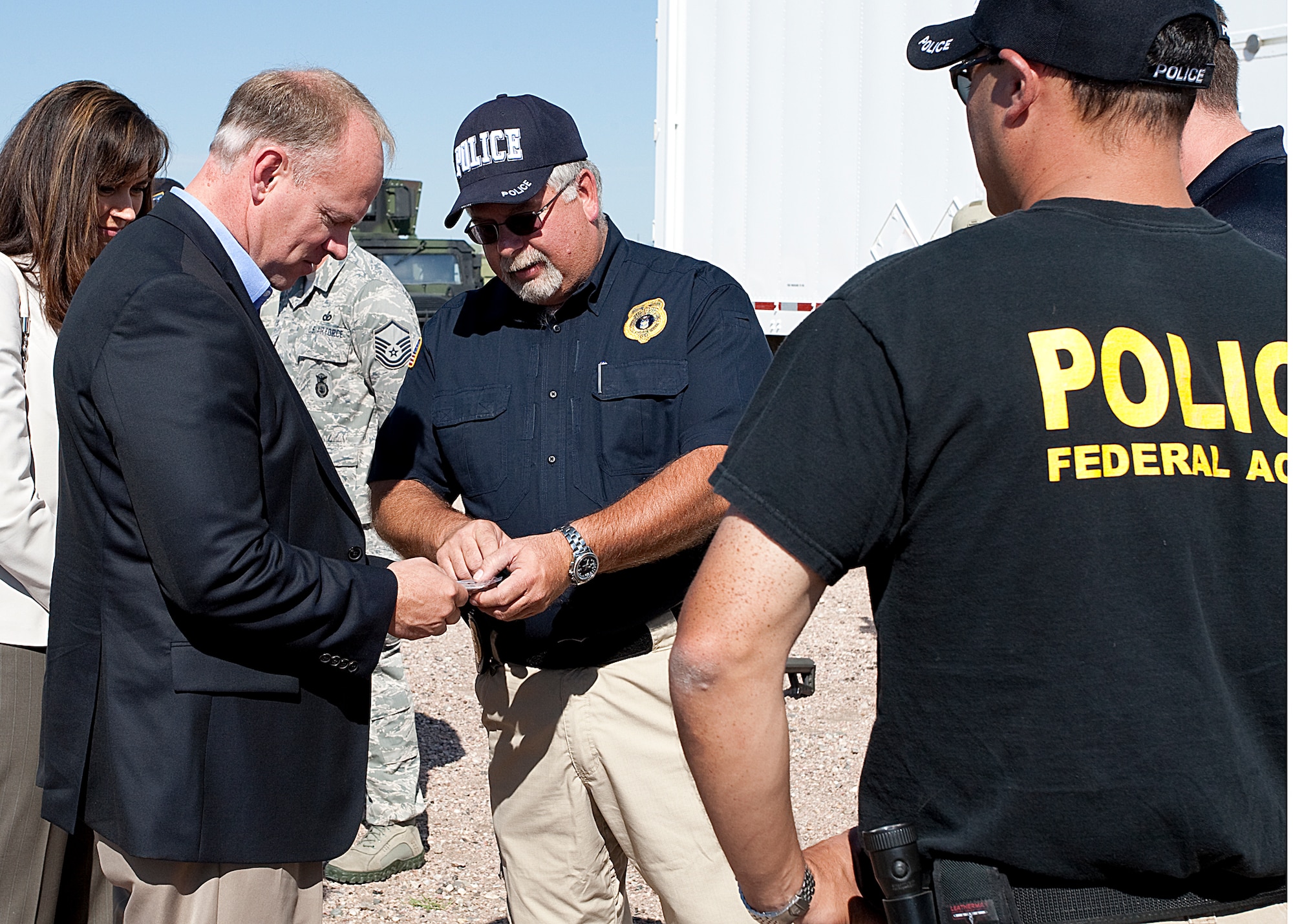 Special Agent Steve Collins presents an OSI coin to Wyoming Governor Matt Mead. OSI talked with the governor and his wife about OSI's mission in support of Air Force Global Strike at F.E. Warren Air Force Base, Wyo. (U.S. Air Force Photo)