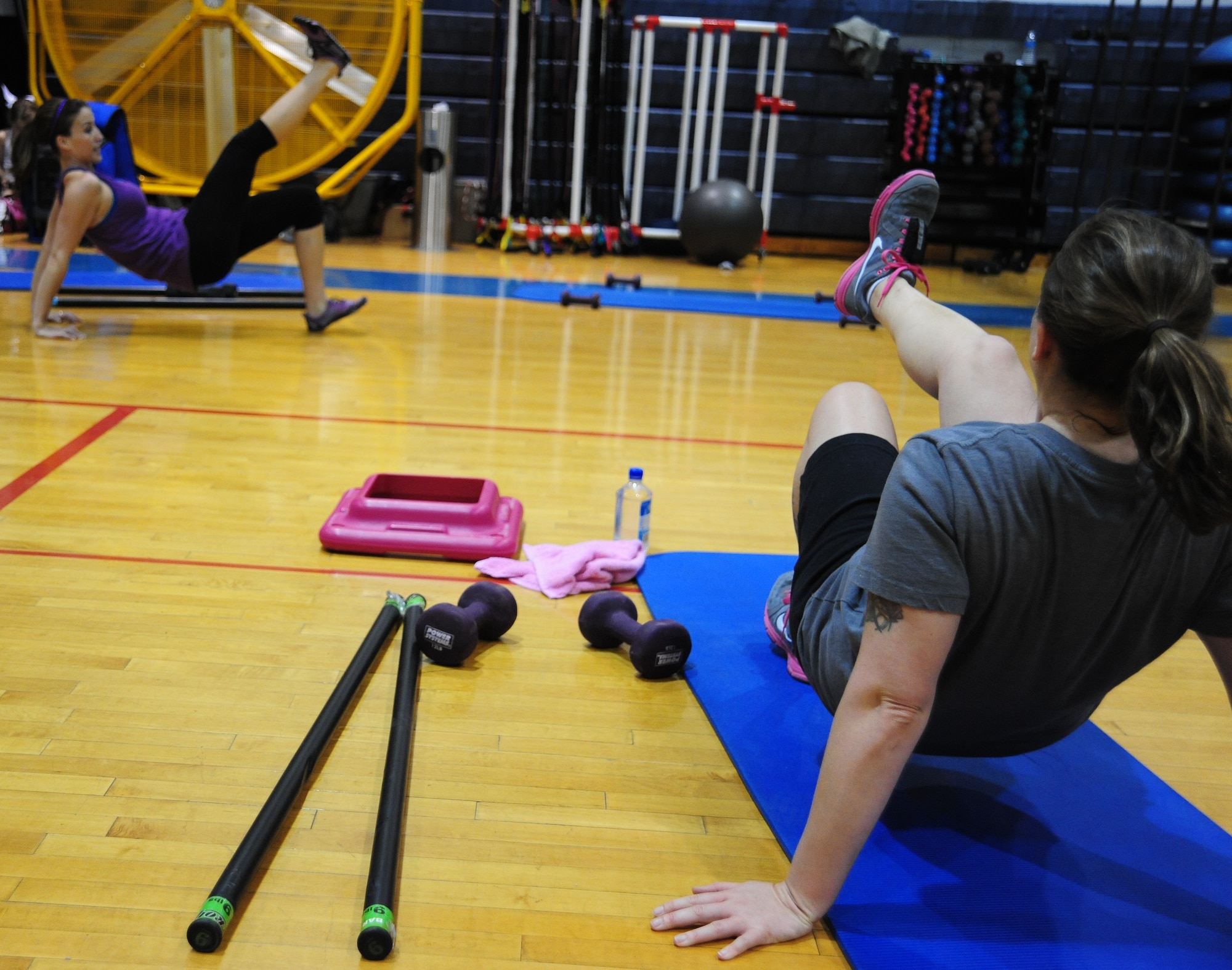 WHITEMAN AIR FORCE BASE, Mo. – Kelly Perry, left, 509th Force Support Squadron fitness center personal trainer, leads a physical training session as Staff Sgt. Wendy Wray, left, 131st Aircraft Maintenance Squadron propulsion technician, participates at the fitness center basketball court Dec. 22. The 509th Force Support Squadron’s fitness center will be hosting their annual Wing Fitness Day event Jan. 6 from 10 a.m. to 3 p.m. The event will be used to introduce new instructors and their classes and demonstrate various fitness center activities. (U.S. Air Force photo/Senior Airman Nick Wilson)