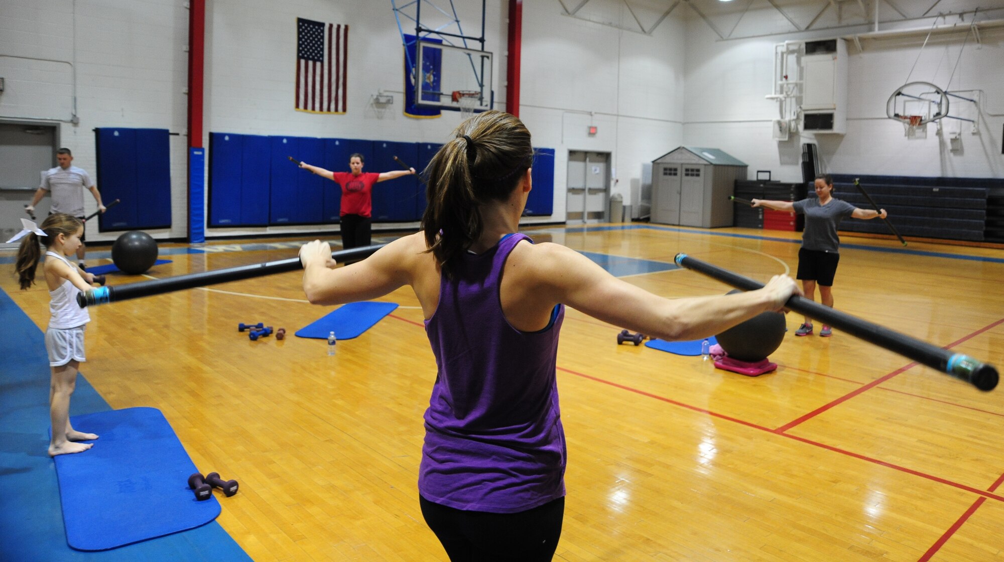 WHITEMAN AIR FORCE BASE, Mo. – Members of the base community participate in a fitness training session led by a personal trainer at the fitness center basketball court Dec. 22. The 509th Force Support Squadron’s fitness center will be hosting their annual Wing Fitness Day event Jan. 6 from 10 a.m. to 3 p.m. The event will be used to introduce new instructors and their classes and demonstrate various fitness center activities. (U.S. Air Force photo/Senior Airman Nick Wilson)