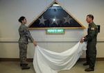 Airman 1st Class Victoria Immanivong (left) assists Maj. Gen. Byron Hepburn during an unveiling ceremony for a Hero's Highway flag Jan. 5, 2012, at Wilford Hall Ambulatory Surgical Center, Lackland Air Force Base, Texas. The flag was previously displayed at the Air Force theatre hospital, Balad Air Base, Iraq, from January 2007 to January 2008 and was donated to the 59th Medical Wing for display. Hepburn is commander of the 59th MDW and director of the San Antonio Military Health System. Immanivong is a 59th MDW medical technician who was one of the last to serve at the hospital before it closed in November 2011. (U.S. Air Force photo by Staff Sgt. Micky M. Bazaldua)
