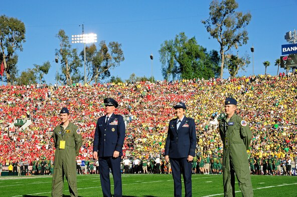 PASADENA, Calif. - Lt. Gen. Ellen Pawlikowski , commander of the Space Missile Systems Center at Los Angeles AFB, Calif,; Brig. Gen. Scott Vander Hamm, commander of the 509th Bomb Wing, Whiteman AFB, Mo.; Maj. Kent Mickelson; and Capt. John Roe are recognized during an on field tribute to Whiteman AFB and the B-2 Spirit during the 98th Rose Bowl in Pasadena, Calif., Jan. 2. The Pasadena Tournament of Roses Association was the organizer of the game and dedicated the game in honor of all wounded military personnel. (U.S. Air Force photo/Jennifer Greene)