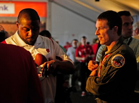 PASADENA, Calif. - Capt. Jon Roe, 393rd Bomb Squadron, gets an autograph from Ron Dayne, the two-time Rose Bowl MVP and 1999 Heisman Trophy Award winner from University of Wisconsin. Dayne was inducted into the Rose Bowl Hall of Fame in Pasadena, Calif., Dec. 31, 2011. (U.S. Air Force photo/Jennifer Greene) 