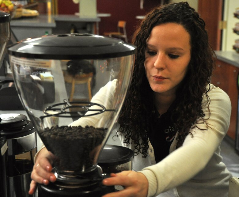 Ashlie Compton, 9th Force Support Squadron barista, prepares coffee beans for a customer at the Coyote Cafe Jan. 5, 2012. Compton said her goal is to go the extra mile to satisfy each customer and have them leave with a smile. (U.S. Air Force photo by Senior Airman Chuck Broadway/Released)