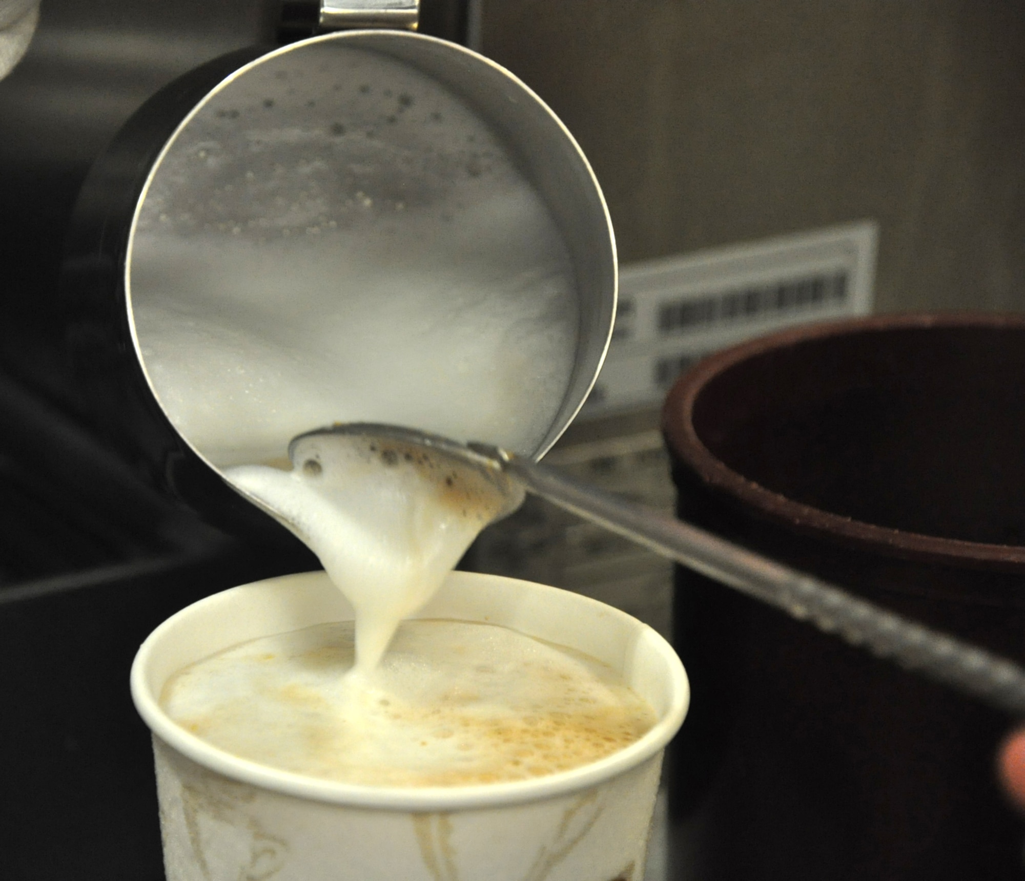 Ashlie Compton, 9th Force Support Squadron barista, pours milk into a drink Jan. 5, 2012 at the Coyote Cafe. The cafe opened Jan. 3 in the Community Activities Center and offers drinks, solid foods, newspapers and free Wi-Fi for customers. (Air Force photo by Senior Airman Chuck Broadway/Released)