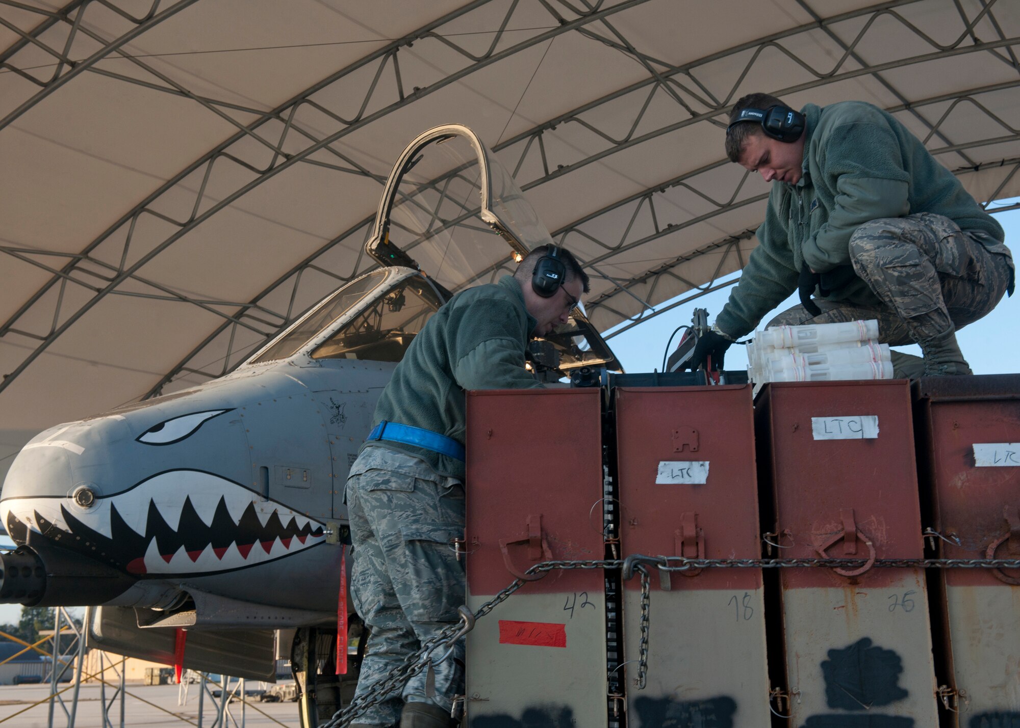 U.S. Air Force Senior Airmen Timothy Staab and Michael Morford, both from the 23rd Aircraft Maintenance Squadron, use an ammunition loading adaptor to feed 30-millimeter ammunition rounds into an A-10C Thunderbolt II during a pilot upgrade training session at Moody Air Force Base, Ga., Jan. 5, 2011. This was the second time the aircraft has flown since the holiday break, and the 23rd AMXS is back to work in preparation for the upcoming operational readiness inspection scheduled for March 28 to April 4. (U.S. Air Force photo by Senior Airman Eileen Meier/Released)