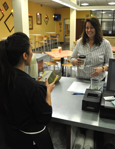 Pamela Taylor, 9th Force Support Squadron caterer, discusses products with Ashley Murphy, 9th FSS barista, Jan. 5, 2012 at the newly opened Coyote Cafe. The cafe opened Jan. 3, in the Community Activities Center and provides coffees, teas and breakfast foods for Team Beale members. (Air Force Photo by Senior Airman Chuck Broadway/Released)