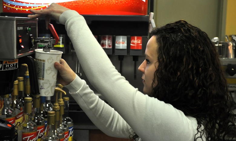 Ashlie Compton, 9th Force Support Squadron barista, prepares a drink for a customer Jan. 5, 2012 at the Coyote Cafe. The cafe opened Jan. 3, in the Community Activities Center and provides coffees, teas and breakfast foods for Team Beale members. (Air Force Photo by Senior Airman Chuck Broadway/Released)