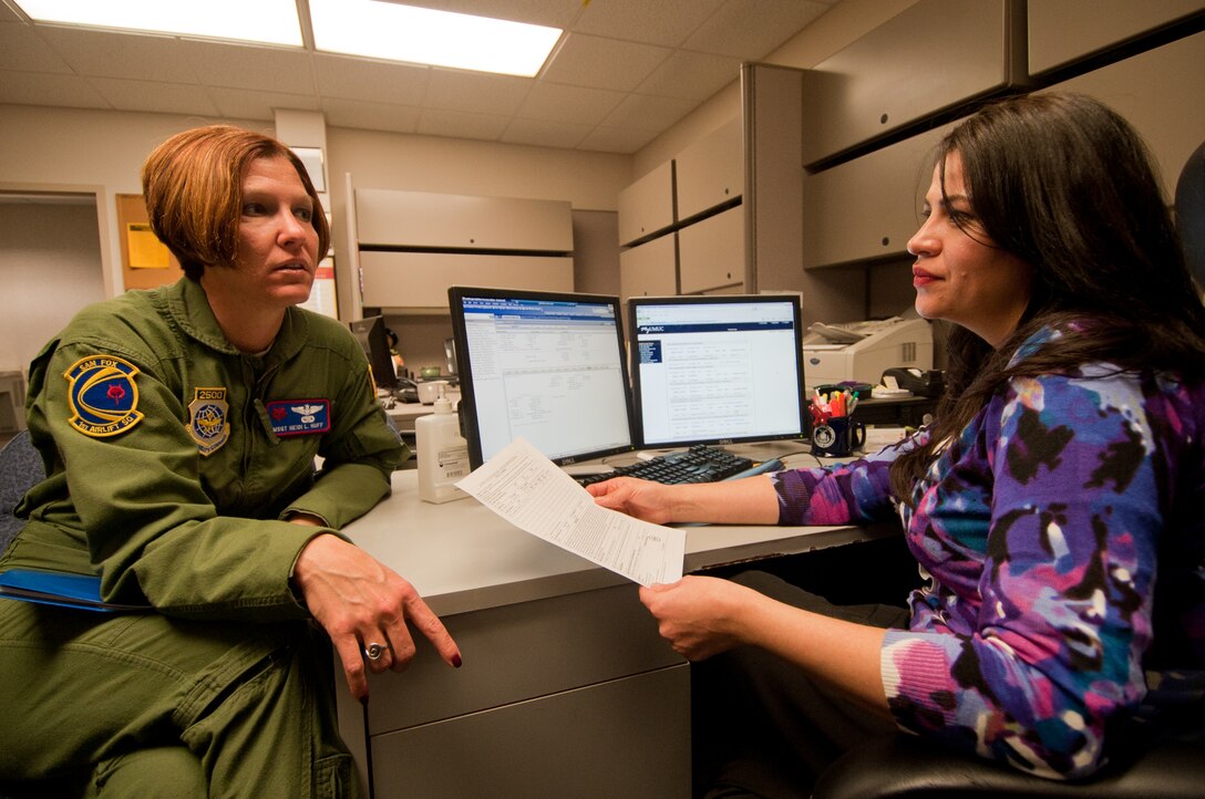 Master Sgt. Heidi L. Huff, 1st Airlift Squadron section chief of training, discuss a degree program at the Andrews Education Center with Yvonne Loya, University of Maryland University College counselor, in preparation for the upcoming winter semester Jan. 3. (Photo/Bobby Jones)  