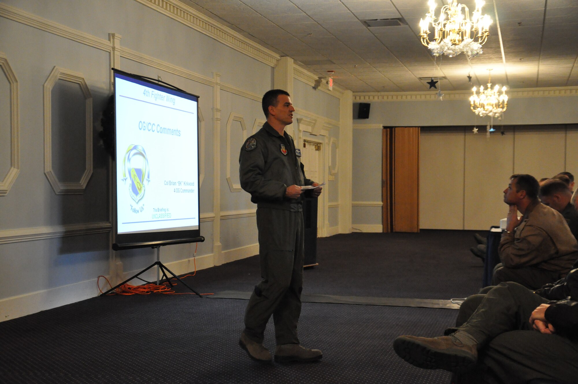 Col. Brian Kirkwood, 4th Operations Group (OG) commander, addresses a room of pilots and weapon systems officers (WSOs) at the 4th Quarter Flight Safety Meeting on Seymour Johnson Air Force Base, N.C., Jan. 3, 2012. The meeting was held for pilots and WSOs from the 4 OG to remind them of aircrew regulations, the hazards of flying during winter months, and animals that could affect their flight and what they can expect this year as they crack down on regulations. (U.S. Air Force photo by Airman 1st Class Mariah Tolbert)