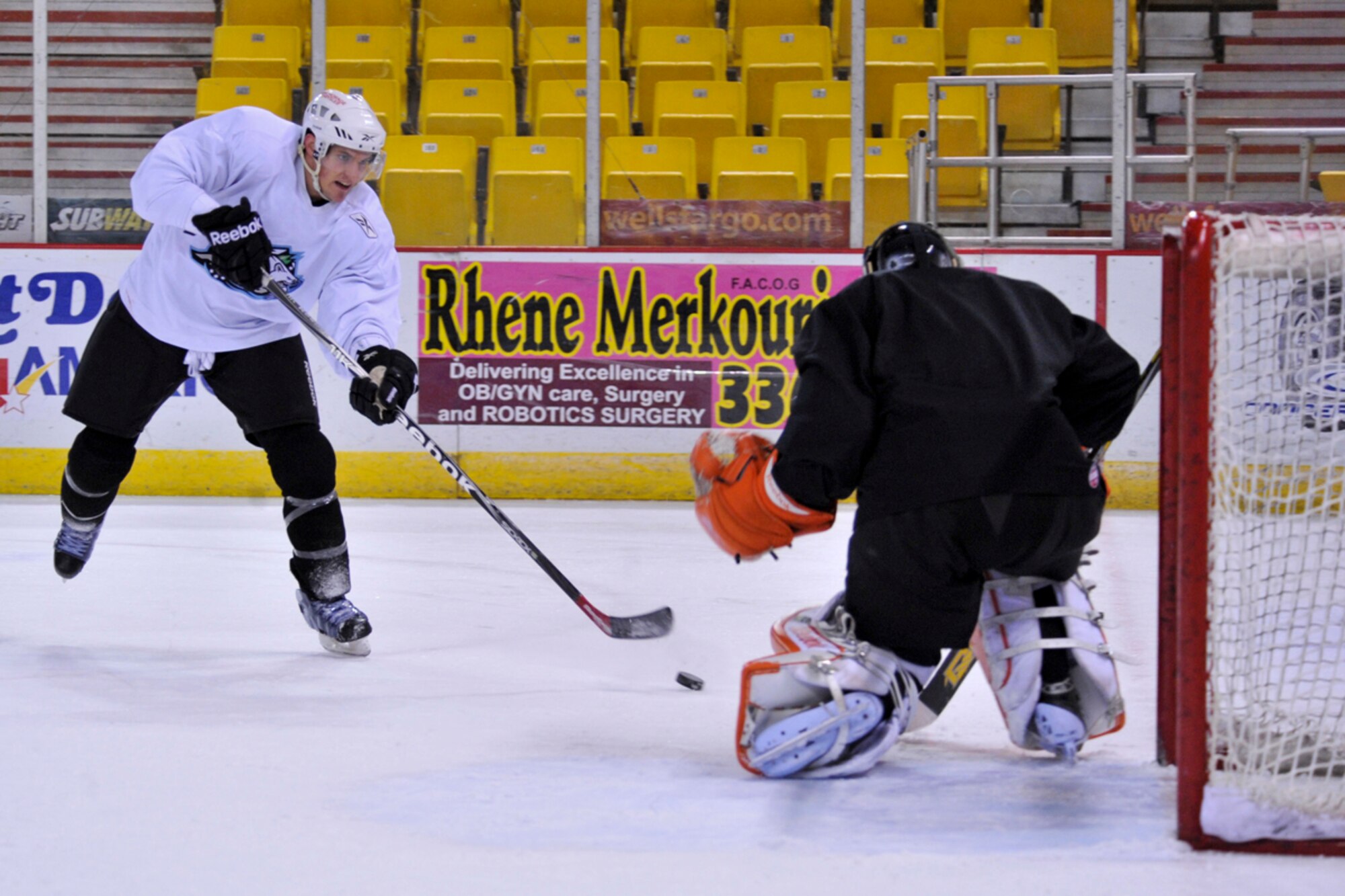 ANCHORAGE, Alaska  ?  Jacques Lamoureux, in white, left wing for the Alaska Aces, shoots the puck during a practice at the Sullivan Arena Dec. 28. Lamoureaux not only plays professional hockey with the Aces, he?s also a second lieutenant assigned to the 673d Contracting Squadron at Joint Base Elmendorf-Richardson. (U.S. Air Force photo/Senior Airman Christopher Gross)