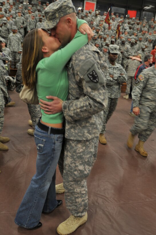 1st Lt. Zack Fulkerson (right), 53rd Transportation Battalion receives a welcome home kiss upon his return from Iraq from his wife, Shelly, the morning of Dec. 21 at Fort Eustis' Anderson Field House. (U.S. Army photo by Sgt. 1st Class Kelly Jo Bridgwater)
