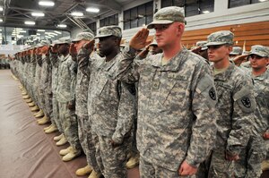 Soldiers of the 89th Transportation Company present arms during the playing of the national anthem at Fort Eustis' Anderson Field House during the unit's welcome home ceremony Dec. 21. (U.S. Army photo by Sgt. 1st Class Kelly Jo Bridgwater)