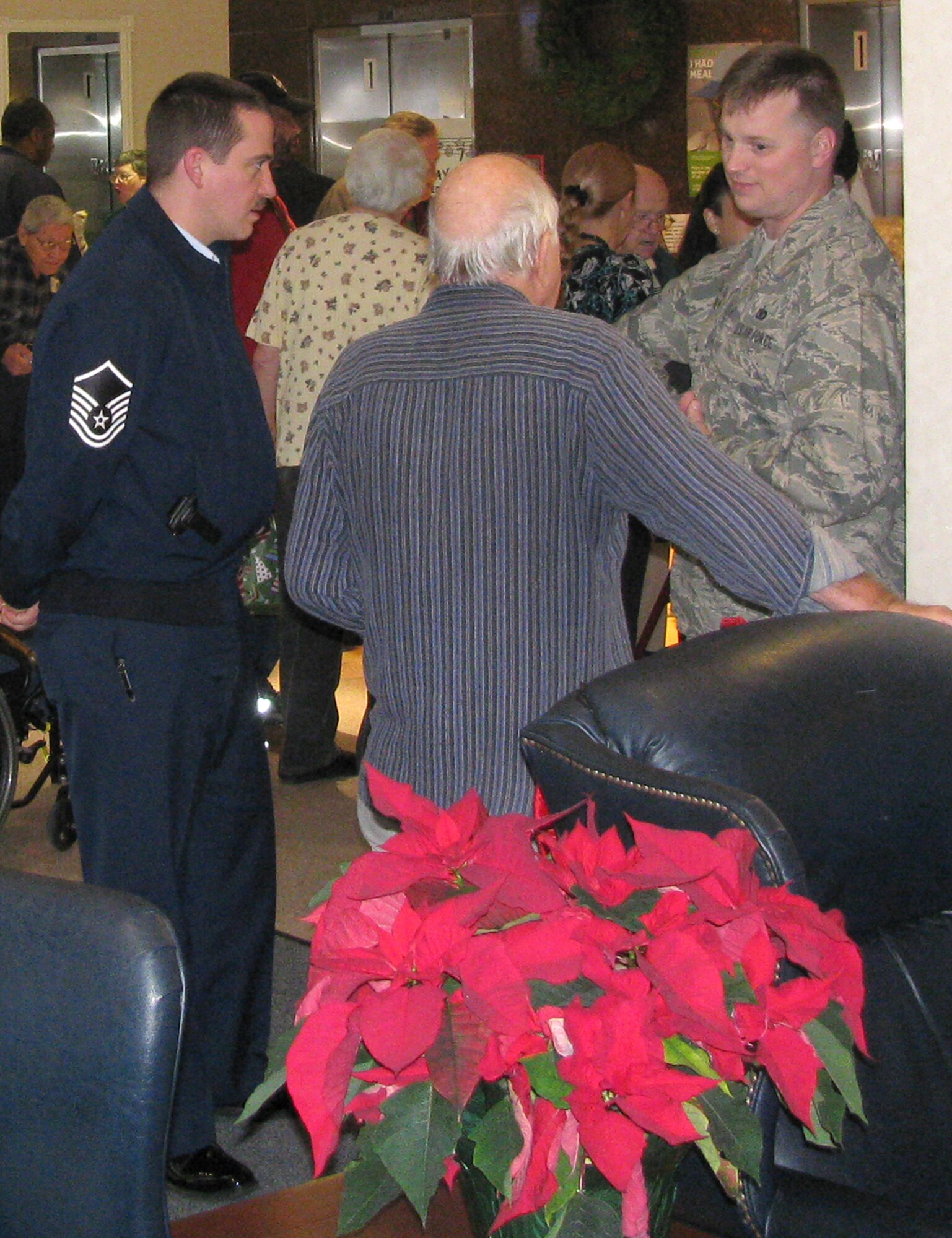 OSI members visit with veterans at the Armed Forces Retirement Home in Washington, D.C. They were there as part of OSI's visit to the home Dec. 21. OSI sponsored a veterans angel tree program in the National Capital Region, collecting more than 100 gifts for the residents of the AFRH.  The gifts were presented at the Hero’s Tree dedication. OSI members from AFOSI Headquarters, Marine Corps Base Quantico, Va., and from all around the NCR joined the residents for lunch and shared some quality time together in celebration of the holiday season. (U.S. Air Force Photo)